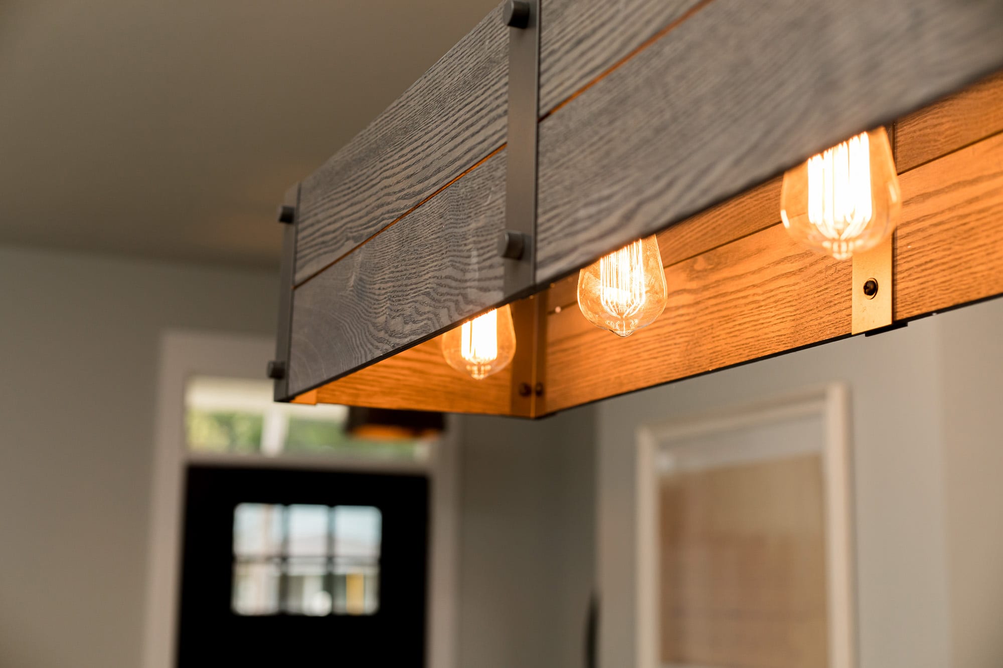 Unique design feature, aDoor rustic lighting set in wood with vintage bulb.
